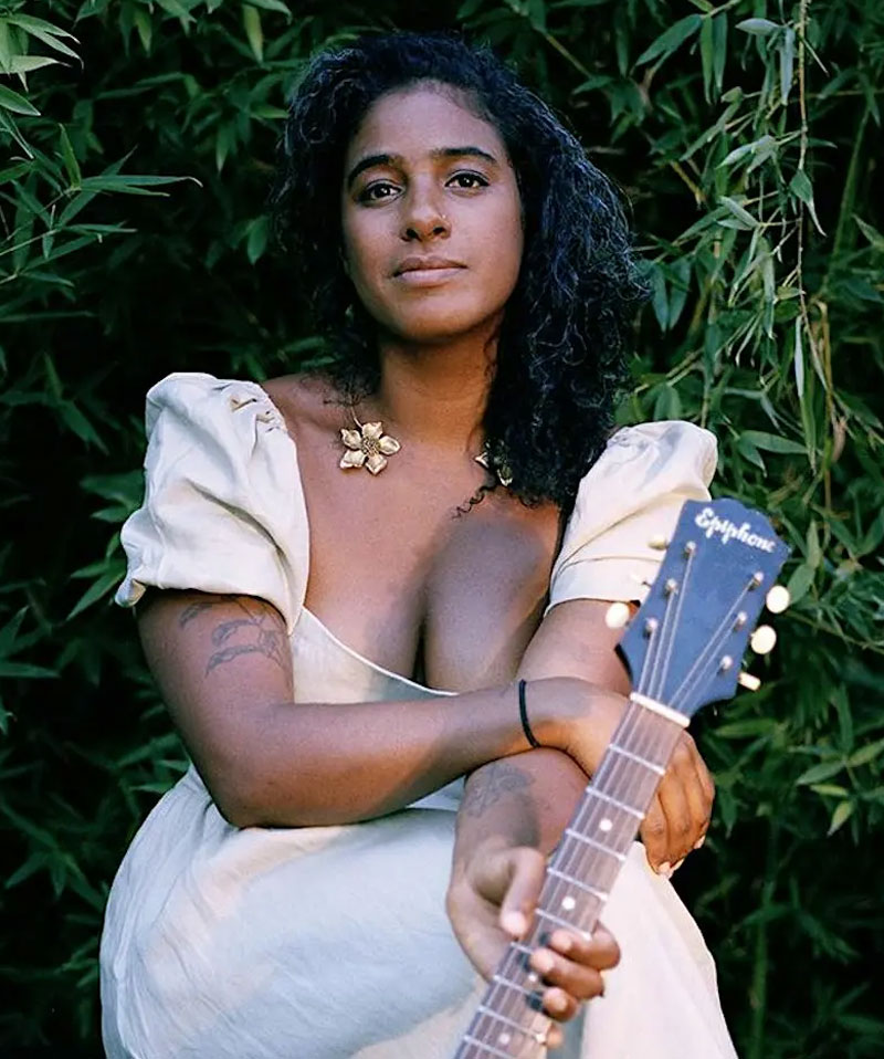 Image of Haitian-American multi-instrumentalist Leyla McCalla with guitar.